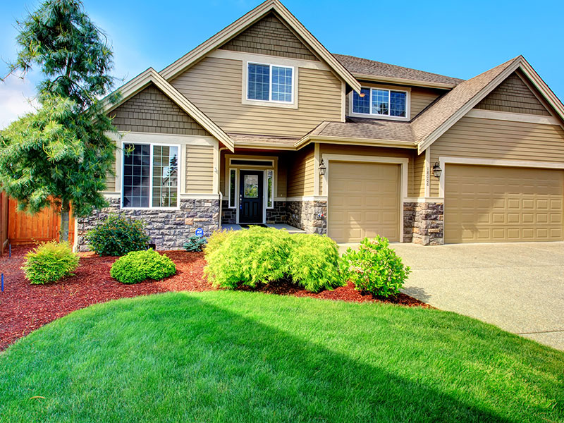 landscaped front yard with a beautiful lawn, showcasing products from South Dallas Turf & Supply.